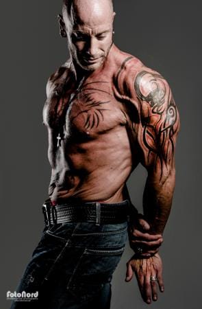 a big tattooed bodybuilder with shaved head