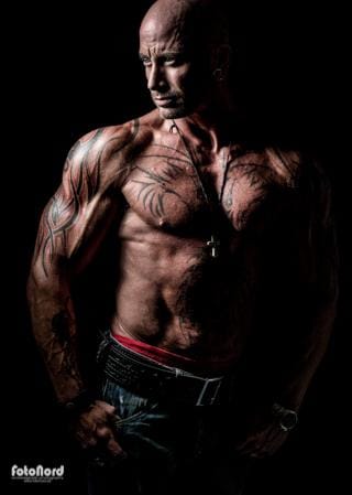 a big tattooed bodybuilder with shaved head