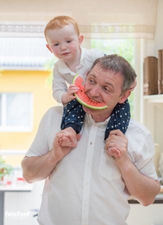 Father and son eating watermelon