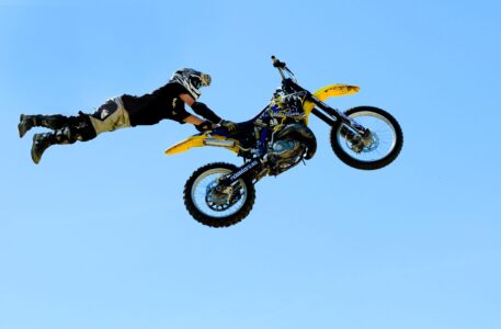 ASELE, SWEDEN - JULY 19: - Motocross rider doing some daring tricks in a high jump at the summer fair in Asele, Sweden, july 19, 2008 motocross jump